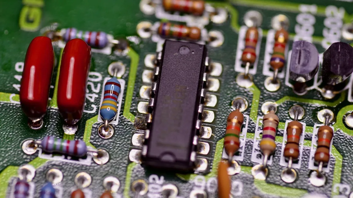 A close-up view of a circuit board with various electronic components, including capacitors, resistors, and integrated circuits.
