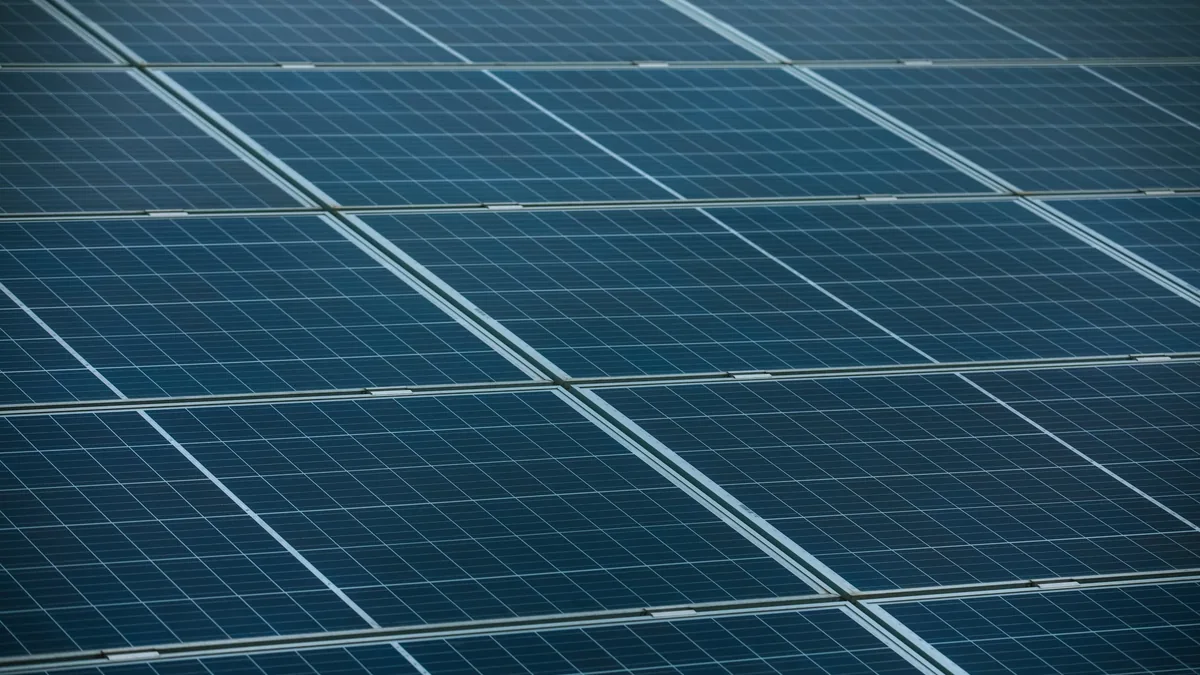 A large array of solar panels, each comprising multiple rectangular cells arranged in a grid pattern.